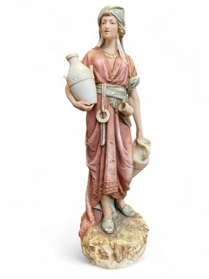 Lot 574 - A Royal Dux porcelain figure of a water carrier.