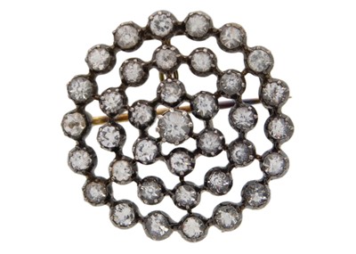 Lot 113 - An early 20th-century white sapphire silver and gold set circular openwork brooch.