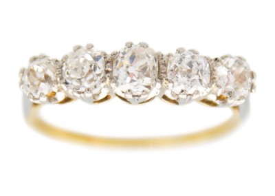 Lot 206 - An 18ct and platinum old mine cut diamond set five stone ring.