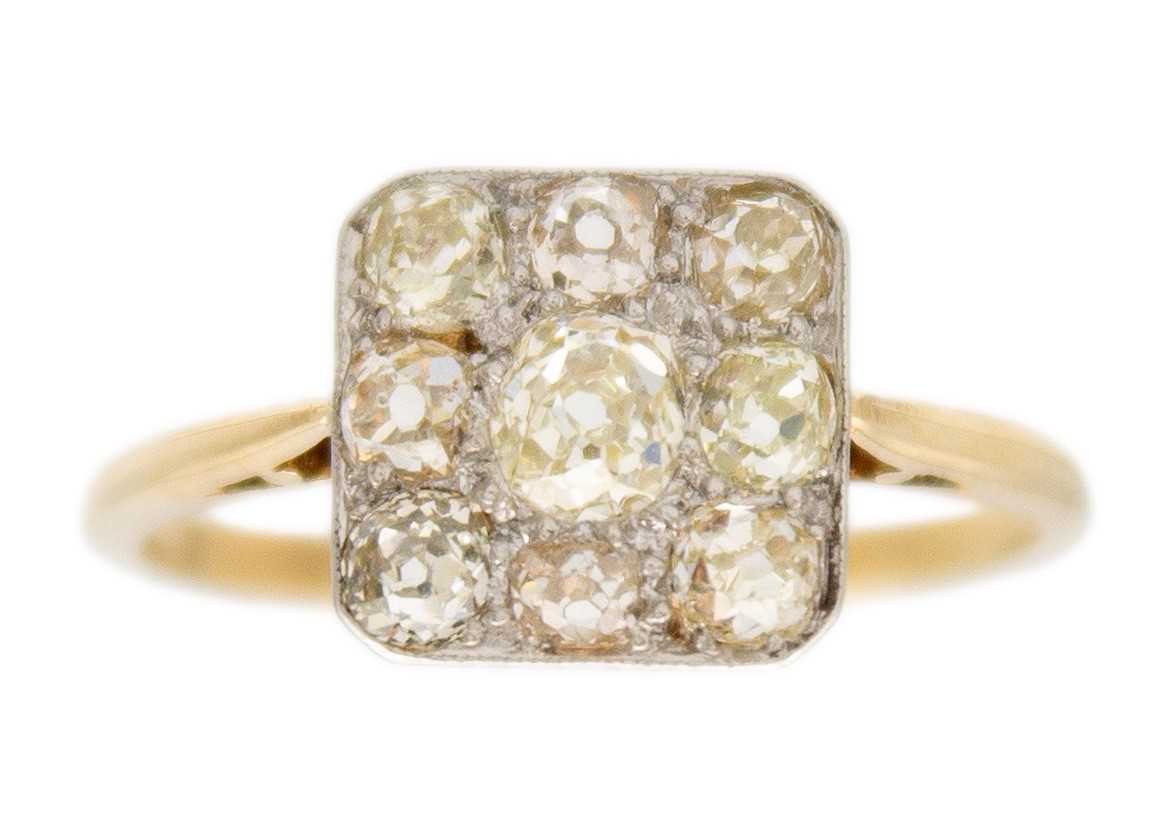 Lot 210 - An Art Deco 18ct yellow and white gold old mine cut set panel ring.