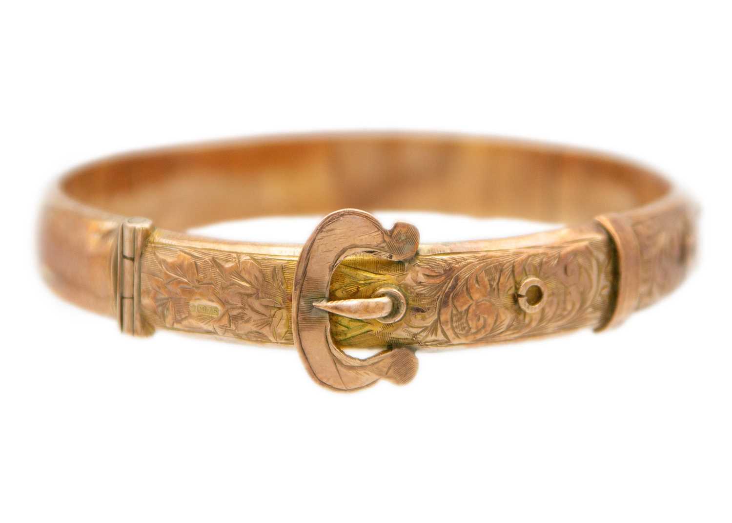 Lot 63 - An early 20th century 9ct rose gold hinged buckle bangle.