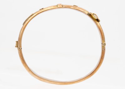 Lot 63 - An early 20th century 9ct rose gold hinged buckle bangle.