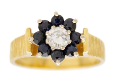 Lot 138 - An 18ct diamond and sapphire set cluster ring.