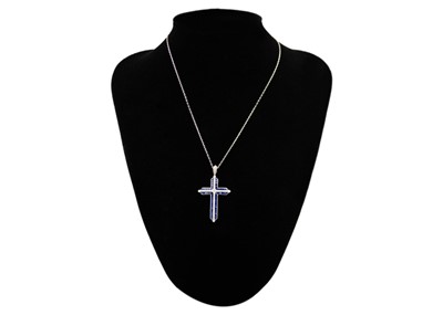 Lot 124 - A stylish 18ct white gold diamond and sapphire set cross pendant necklace.