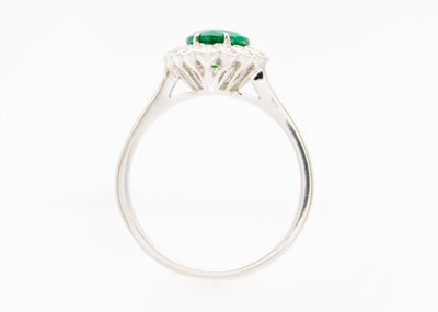 Lot 147 - An attractive 18ct white gold pear cut emerald and diamond set ring.