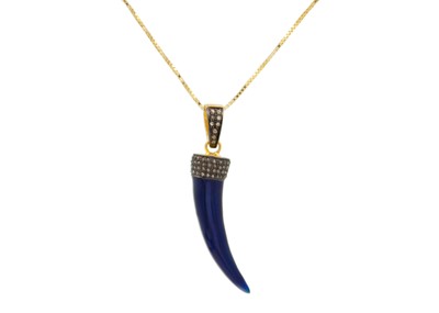 Lot 204 - A dark blue enamel tiger tooth design pendant set with small rose cut diamonds.