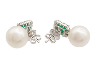 Lot 145 - A pair of 18ct white gold emerald diamond and white cultured pearl earrings.