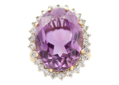 Lot 226 - An 18ct hallmarked yellow and white gold amethyst and diamond set large dress ring.