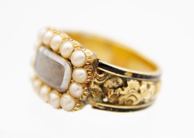 Lot 204 - A George IV 18ct hallmarked gold and black enamel seed pearl set memorial ring.