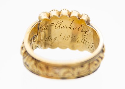 Lot 204 - A George IV 18ct hallmarked gold and black enamel seed pearl set memorial ring.