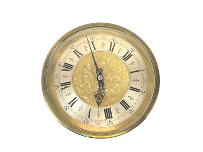 Lot 523 - A brass The Synchrome Co Ltd clock.