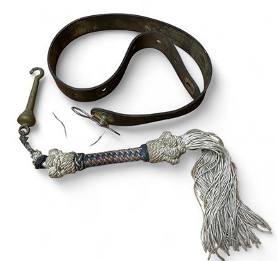 Lot 856 - A leather belt and a brass bell clapper