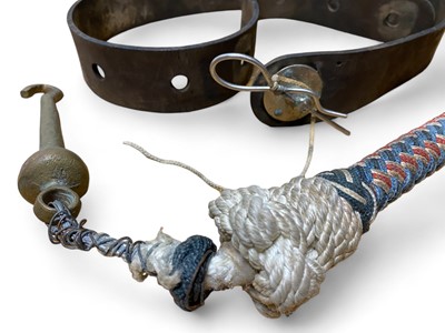 Lot 856 - A leather belt and a brass bell clapper