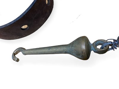 Lot 856 - A leather belt and a brass bell clapper