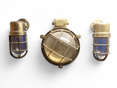 Lot 10 - A caged brass bulkhead lamp