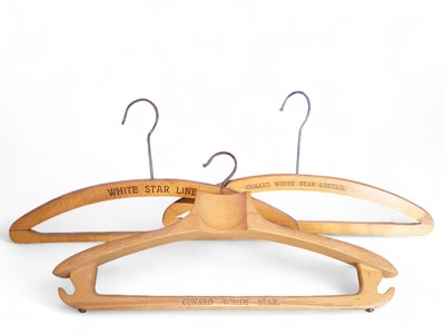 Lot 11 - Cunard White Star Line, three wooden clothes hangers.