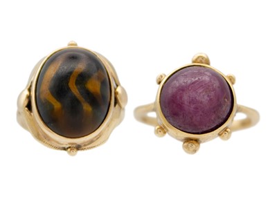 Lot 129 - A 9ct hallmarked gold cabochon ruby set ring and a 9ct tiger's eye set ring.