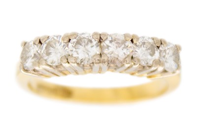 Lot 171 - A modern 18ct yellow and white gold diamond set six stone half hoop ring.