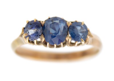 Lot 207 - A 9ct rose gold blue sapphire set three-stone ring.