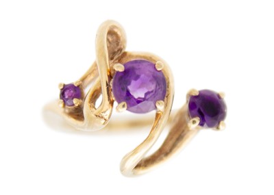 Lot 198 - A Bernard Instone 9ct amethyst set three stone ring.