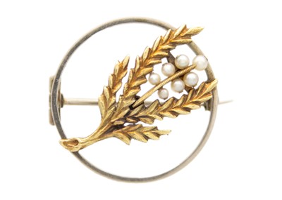 Lot 216 - A yellow and white gold seed pearl set sprig and berry design brooch.