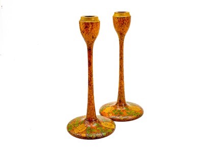 Lot 81 - A pair of Arts and Crafts style poker work candlesticks.