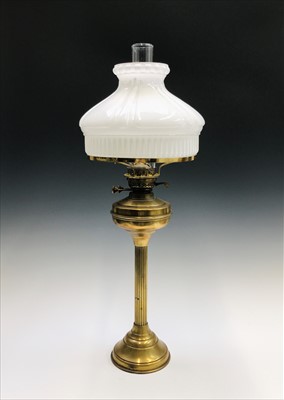 Lot 142 - A brass reeded column oil lamp with circular...