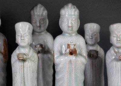 Lot 705 - Six Chinese celadon glazed pottery figures, probably Yuan Dynasty.