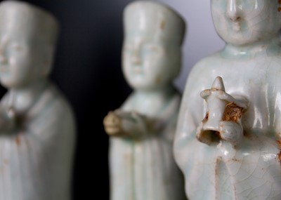 Lot 705 - Six Chinese celadon glazed pottery figures, probably Yuan Dynasty.