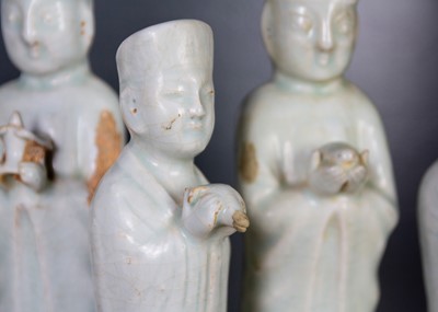Lot 705 - Six Chinese celadon glazed pottery figures, probably Yuan Dynasty.