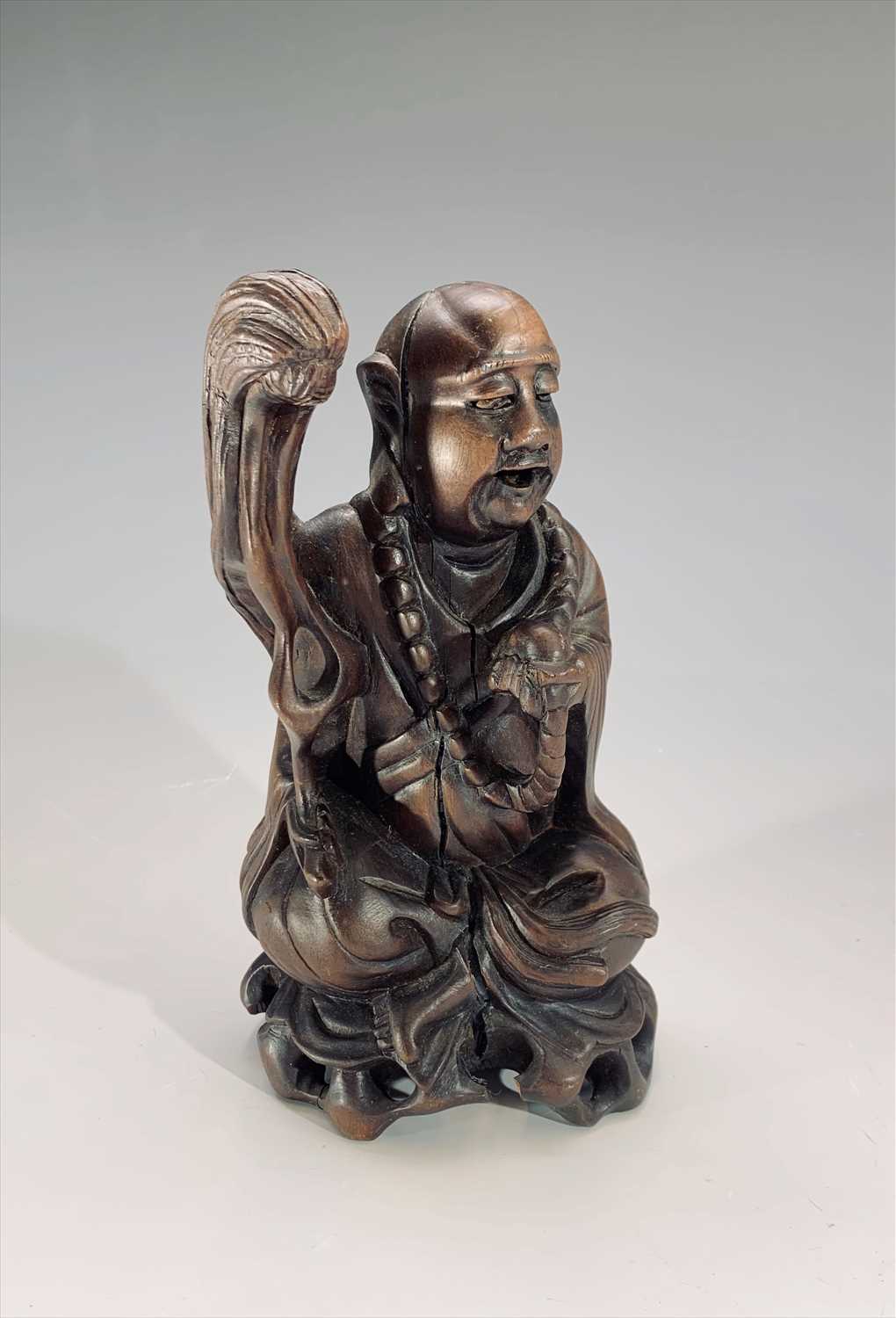 Lot 733 - A Chinese carved wood figure of a seated...