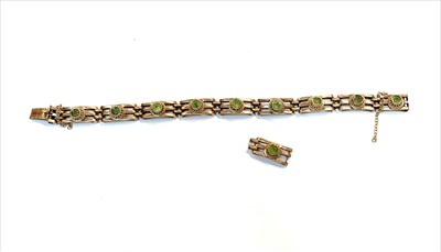 Lot 2484 - A peridot set 9ct gold gate link bracelet,...