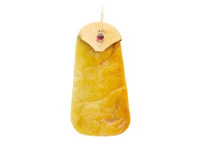 Lot 160 - A carved russet jade pendant with 9ct mount and cabochon garnet set bale.