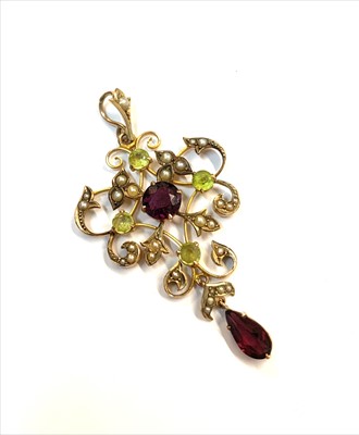 Lot 2485 - A 9ct gold pendant set peridot, red stone and...