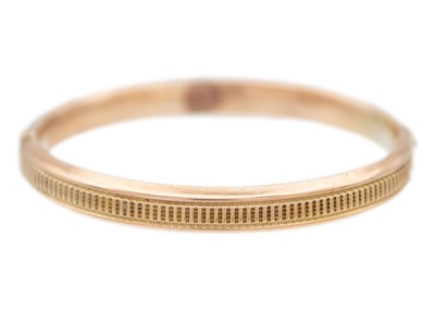 Lot 151 - A 9ct rose gold (tested) hinged hollow bangle.