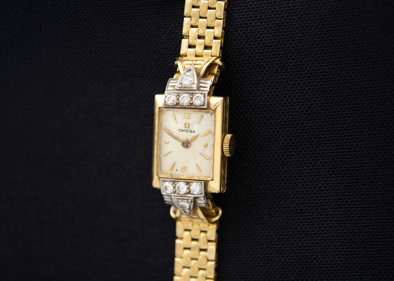 Lot 150 - OMEGA - An 18ct lady's manual wind diamond set bracelet wristwatch.