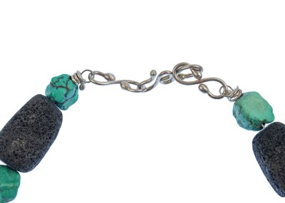 Lot 77 - HELEN FEILER - A volcanic stone and turquoise bead silver necklace.