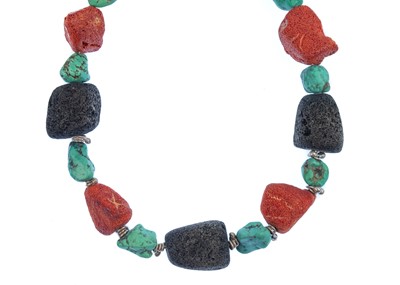 Lot 77 - HELEN FEILER - A volcanic stone and turquoise bead silver necklace.