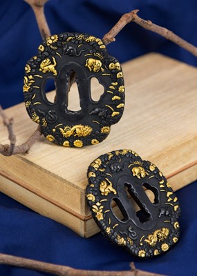 Lot 236 - A matching pair (Daisho) of gold shakudo tsuba.