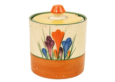 Lot 608 - A Clarice Cliff Crocus pattern drum shape preserve pot and cover.