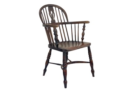 Lot 264 - A dark ash and elm Windsor armchair.