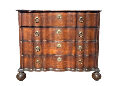 Lot 992 - A Dutch oak double serpentine commode.