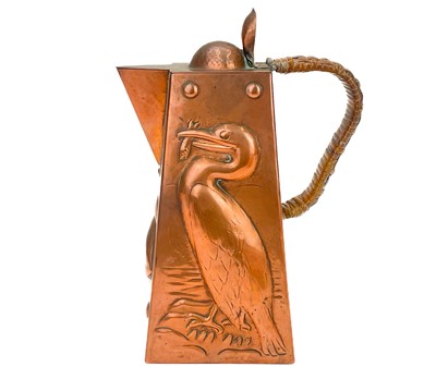 Lot 126 - A Newlyn copper hot water jug and hinged cover.