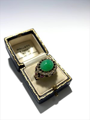 Lot 2405 - An ornate gold ring set with jade, diamonds...
