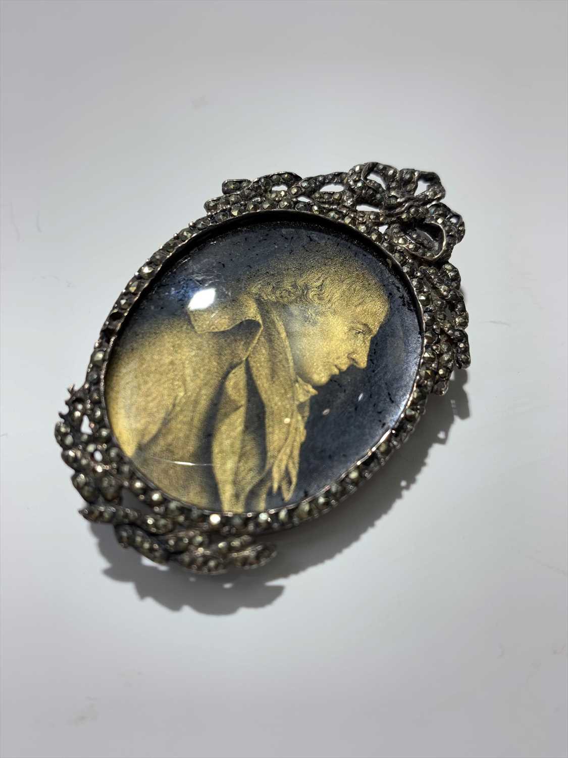 Lot 2416 - An early 19th century verre eglomise portrait...