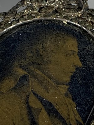 Lot 2416 - An early 19th century verre eglomise portrait...