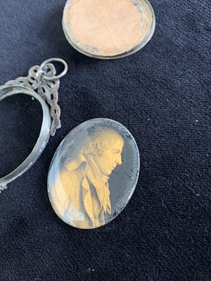 Lot 2416 - An early 19th century verre eglomise portrait...