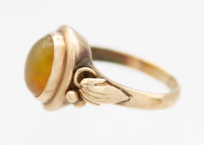 Lot 21 - A rose gold fire opal set ring.