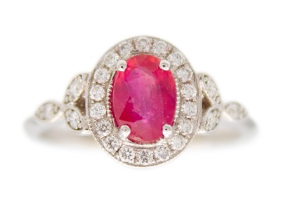 Lot 143 - A 1.03ct ruby and diamond set halo ring, set in 18ct white gold.