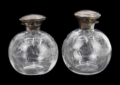 Lot 446 - A pair of English glass scent bottles with silver mounts.